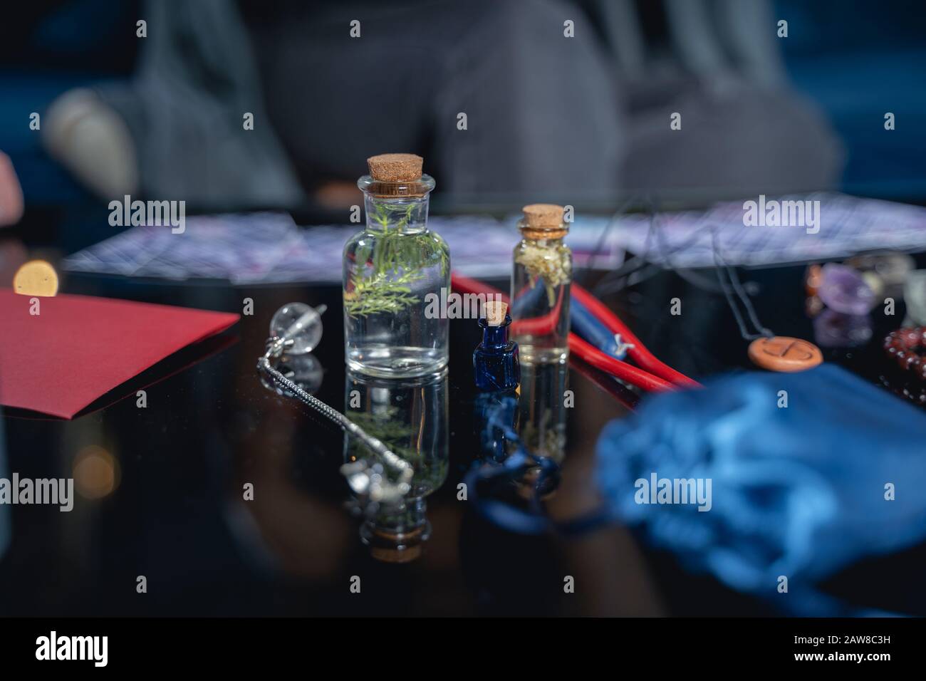 Crystal pendulum and small bottles of potion Stock Photo