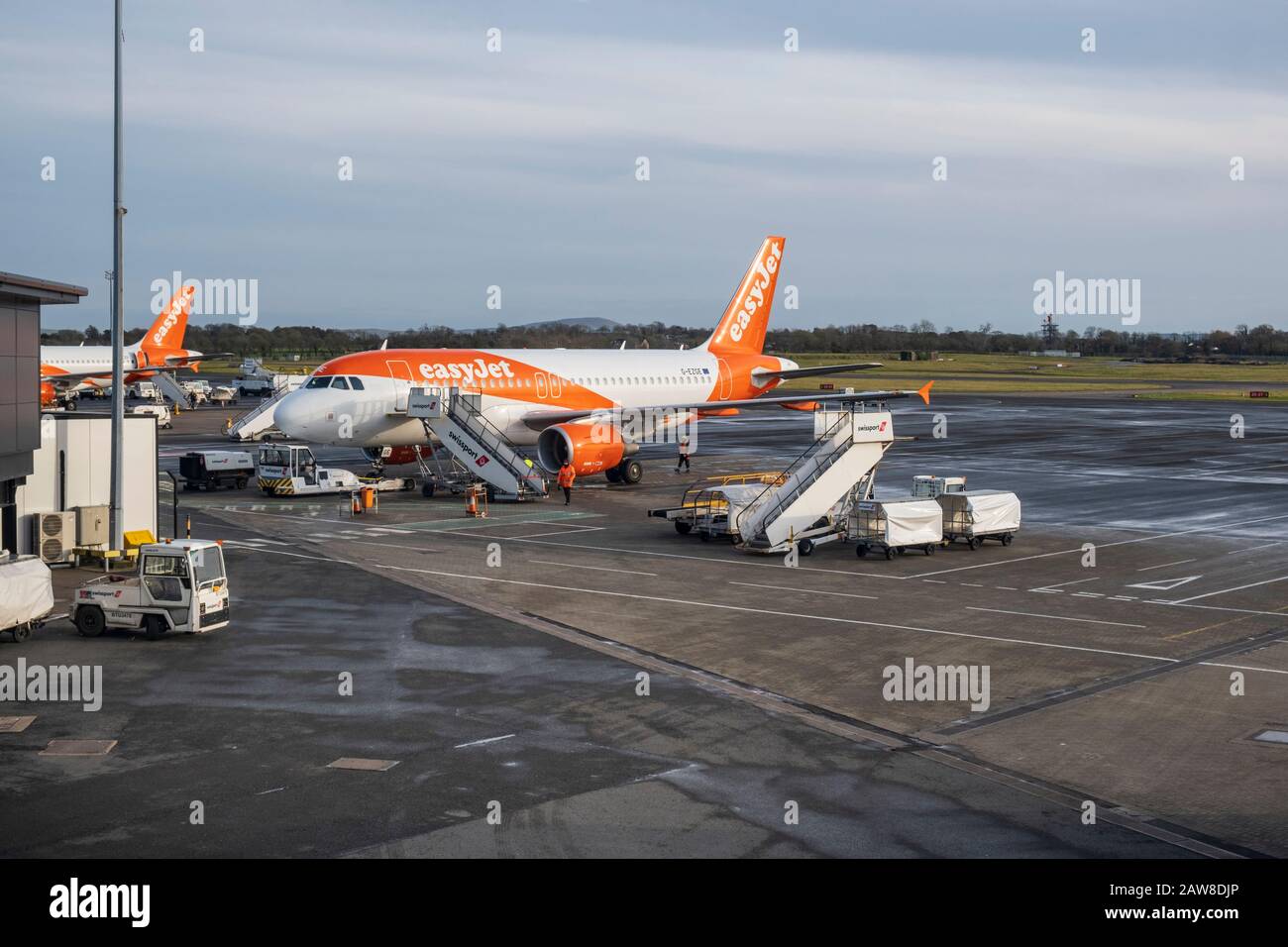 EasyJet aircraft on stand in front of the terminal building apron at Belfast International airport, Aldergrove Stock Photo
