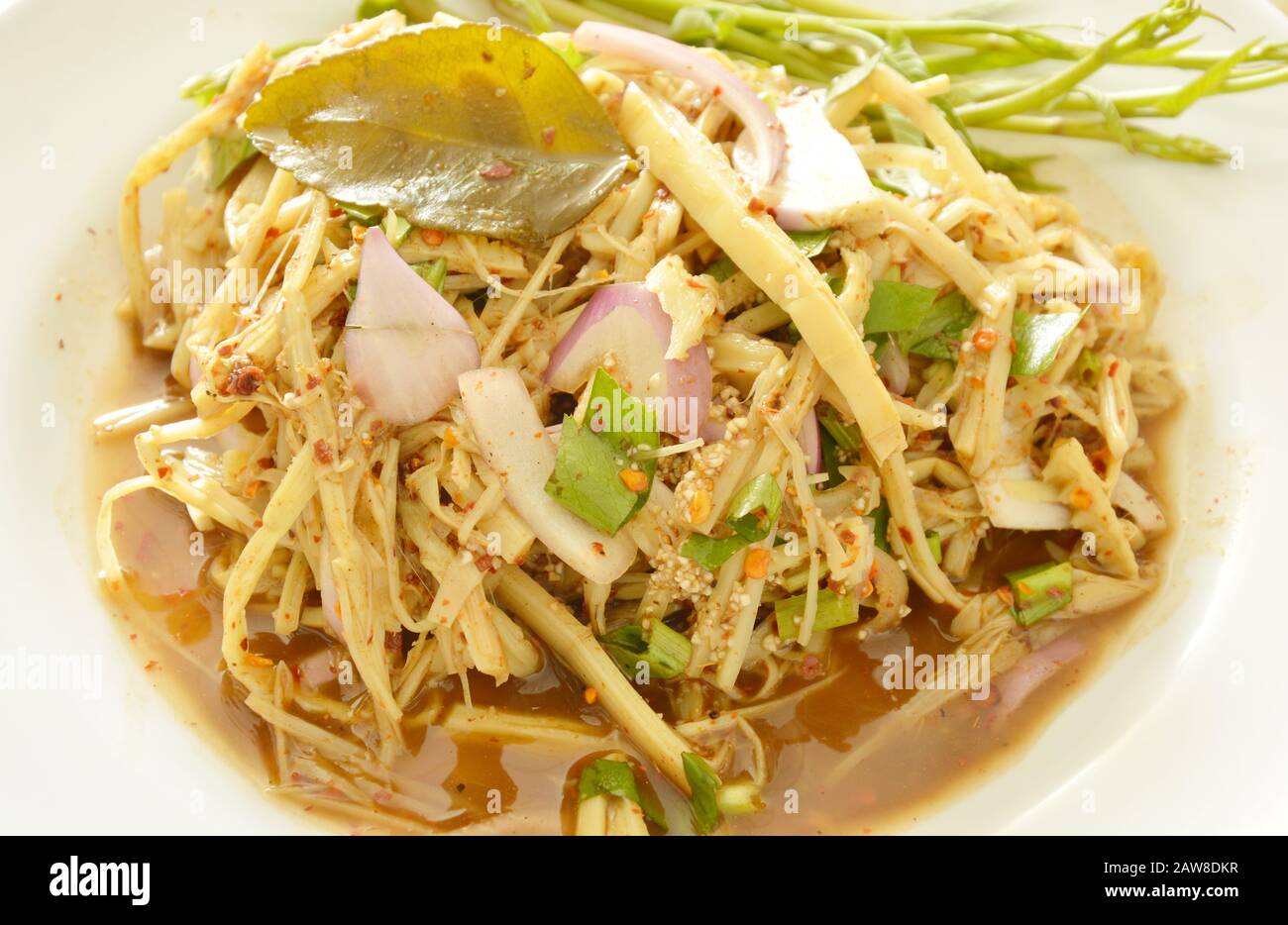 spicy shredded bamboo shoot salad in Thai northeastern style scooping