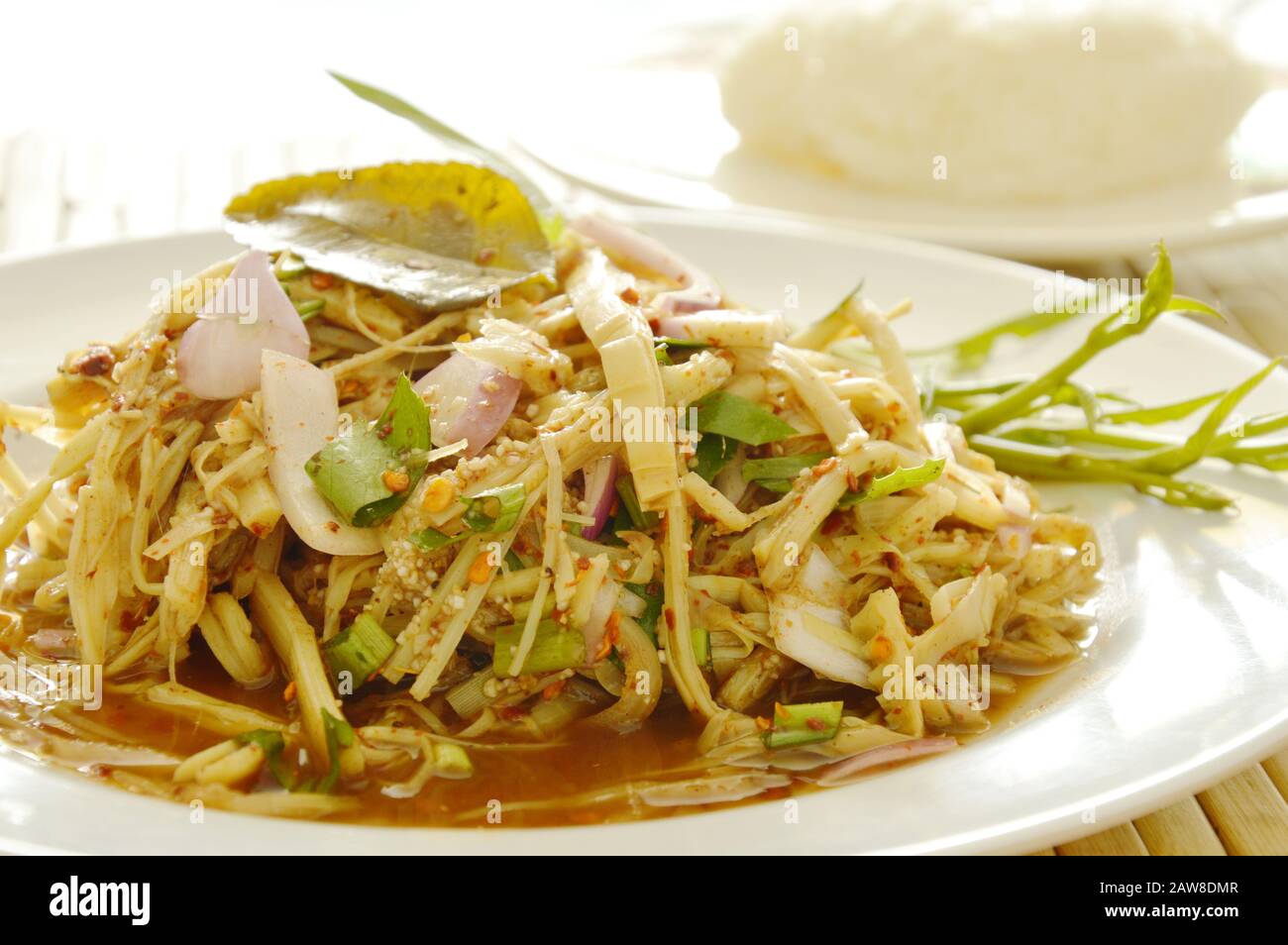 spicy shredded bamboo shoot salad in Thai northeastern style scooping