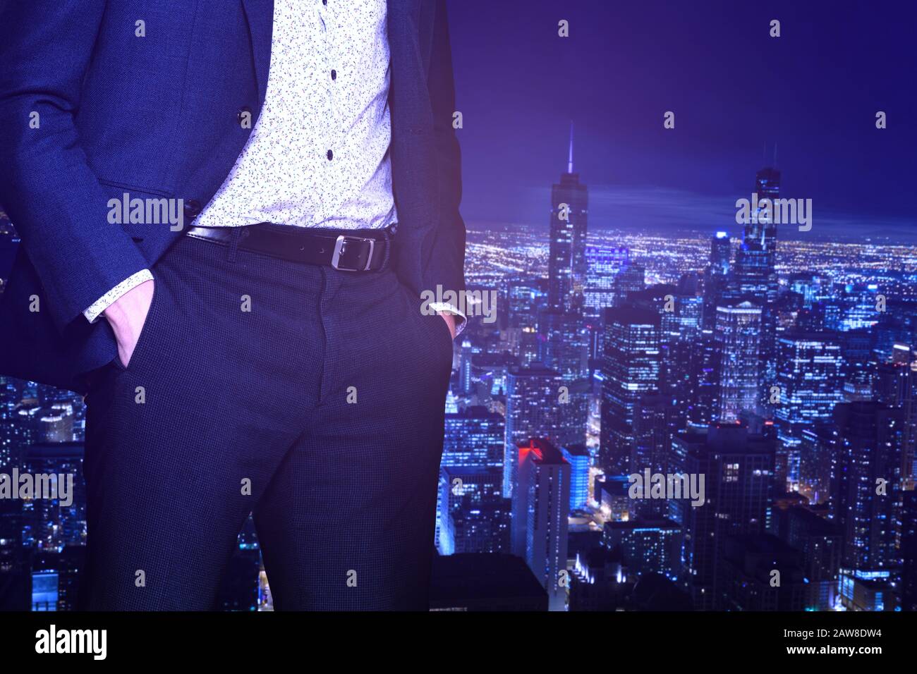 Businessman in suit standing near the window of downtown Chicago ...