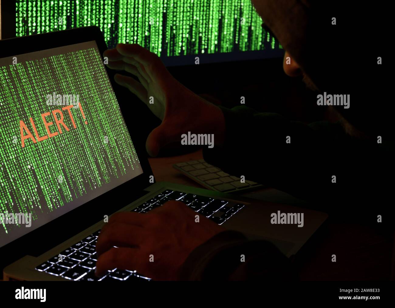 Hacker using computer in the dark Stock Photo