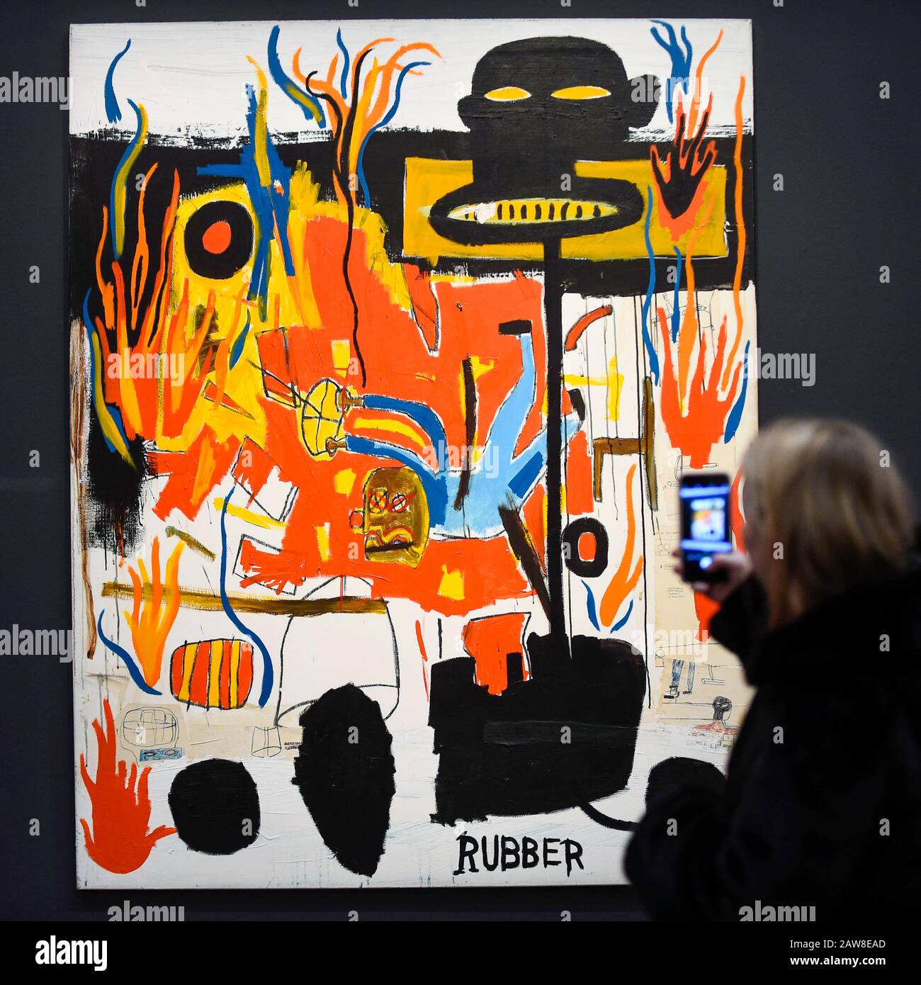 London, UK.  7 February 2020.  A visitor views ''Rubber'' by Jean-Michel Basquiat, (Est. £6,000,000 - 8,000,000). Preview of Sotheby's Contemporary Art Sale in their New Bond Street galleries.  Works by artists including Francis Bacon, Yves Klein, Jean-Michel Basquiat and David Hockney will be offered for auction on 11 February 2020.  Credit: Stephen Chung / Alamy Live News Stock Photo