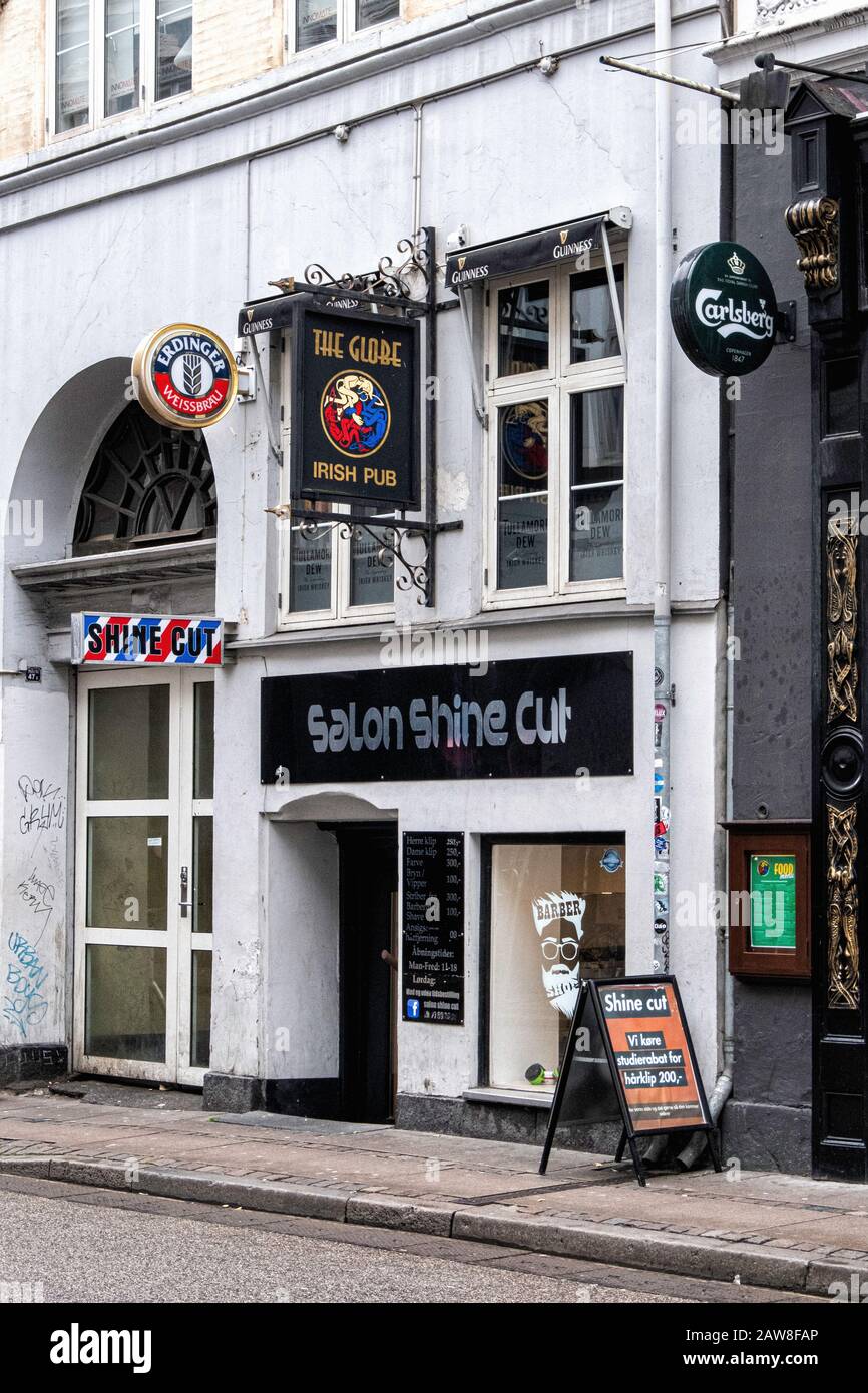The Globe Irish Pub Sign & Salon Shine Cut Barber In  Copenhagen, Denmark Stock Photo