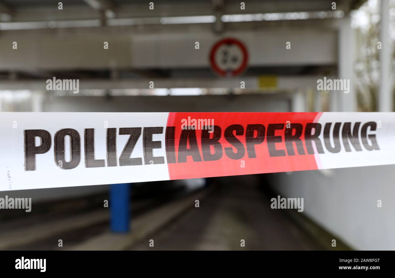 Rostock, Germany. 07th Feb, 2020. The police have put up a barrier tape in front of the entrance and exit of an underground car park in the Toitenwinkel district. A fire in the underground car park on 06.02.2020 destroyed several cars, a van and a motorcycle, and other vehicles were affected by smoke and soot. It is being investigated on suspicion of deliberate arson, with initial estimates of damage to the vehicles alone amounting to around 100 000 euros. Credit: Bernd Wüstneck/dpa-Zentralbild/ZB/dpa/Alamy Live News Stock Photo
