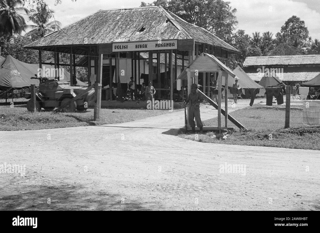 Masamba affair  Polisi Bivouac Masamba [with tents army unit. At the gate is a scoutscar] Annotation: Mambasa affair = Resistance or gang o.l.v. a female councilor from Makassar (Salawati Daud or Lot Salawati) kidnapped and murdered a Dutch representative of a cigarette manufacturer Th. Pluyters. They also attacked a police station and were taking weapons loot. Later, they staged a raid on a prison and freed the prisoners. Date: November 1949 Location: Sulawesi, Indonesia, Masamba, Dutch East Indies Stock Photo