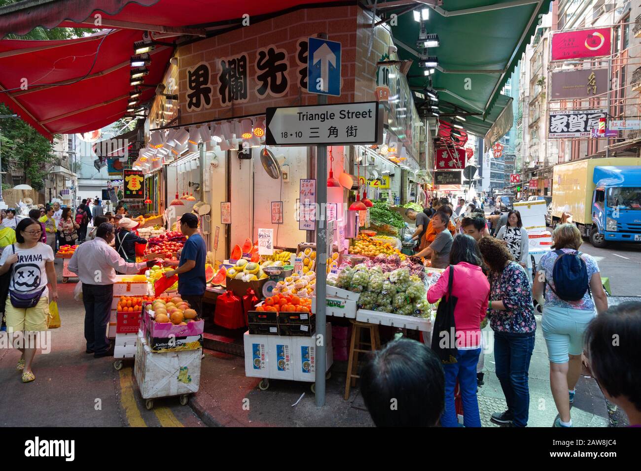 People shopping at shops and stalls on Triangle Street, Wan Chai market