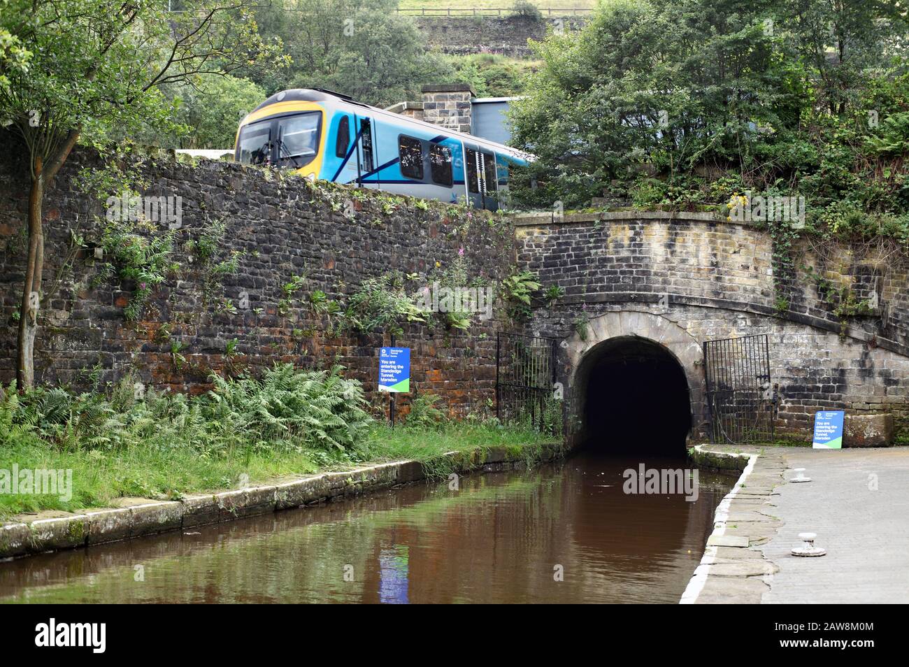 A train passing the north eastern entrance to Standedge canal tunnel, near Marsden, West Yorkshire. Stock Photo