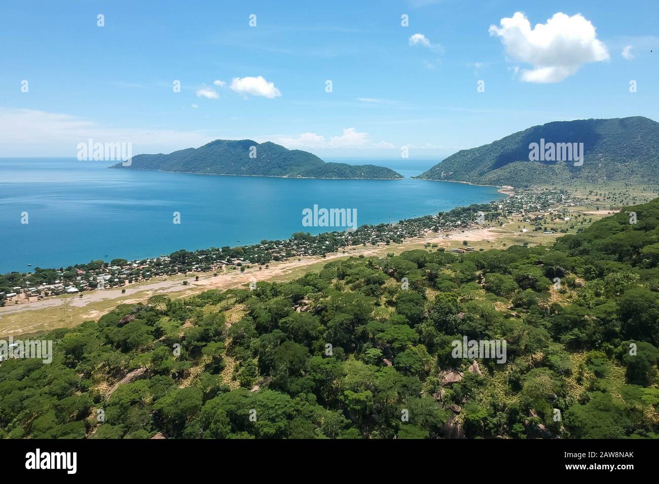 drone shot of the beautiful bay with green mountains in the background Stock Photo