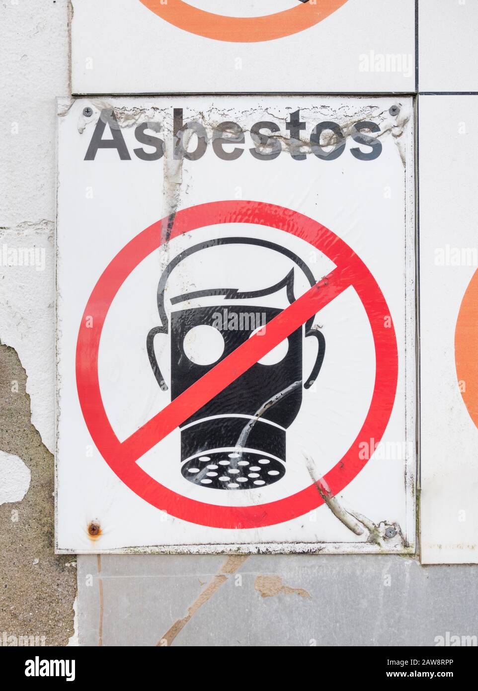 Asbestos hazardous materials warning sign at scrap metal sorting site