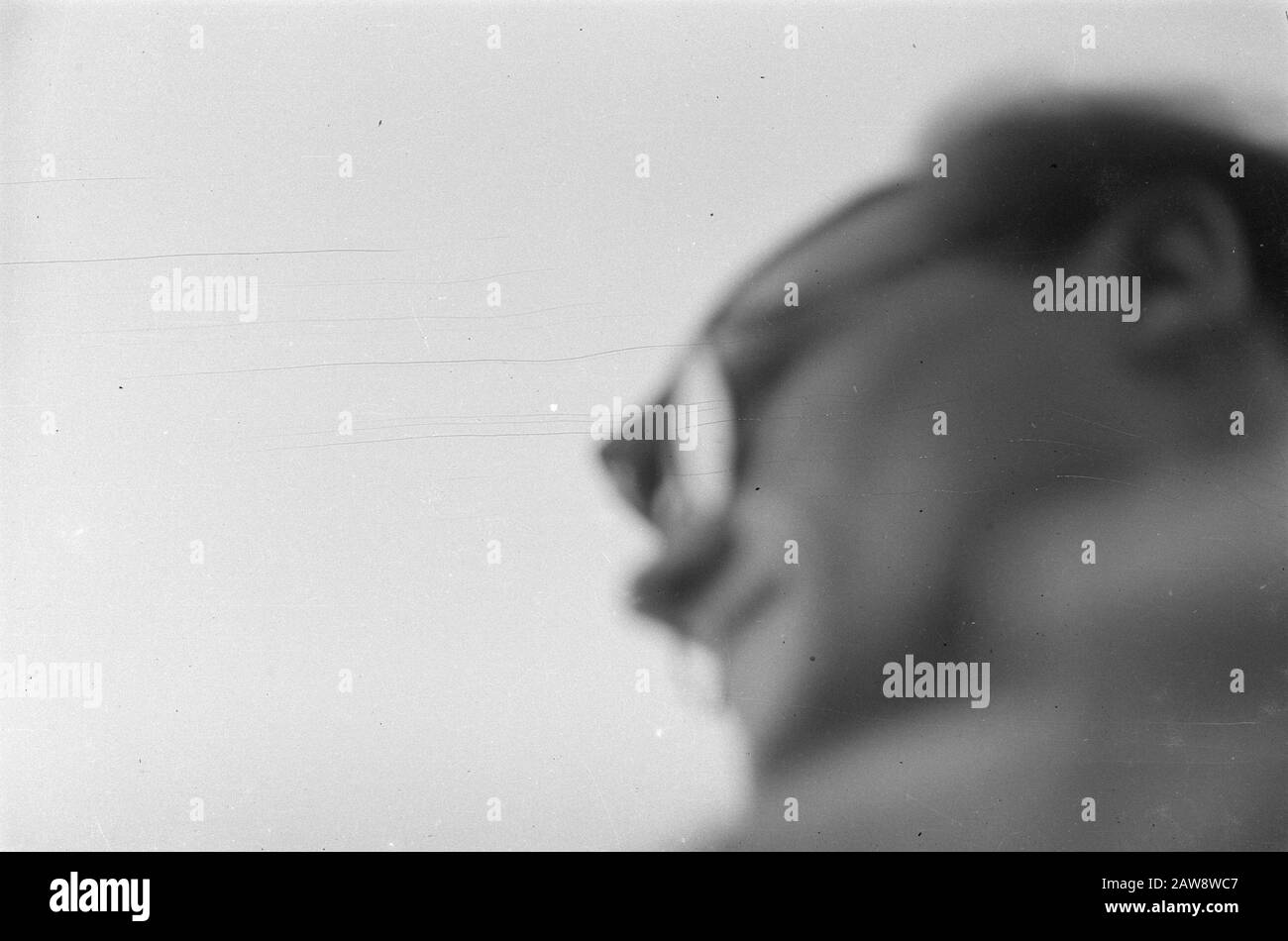 [Failed recording. Head of man with glasses] Date: July 1947 Location: Indonesia Dutch East Indies Stock Photo