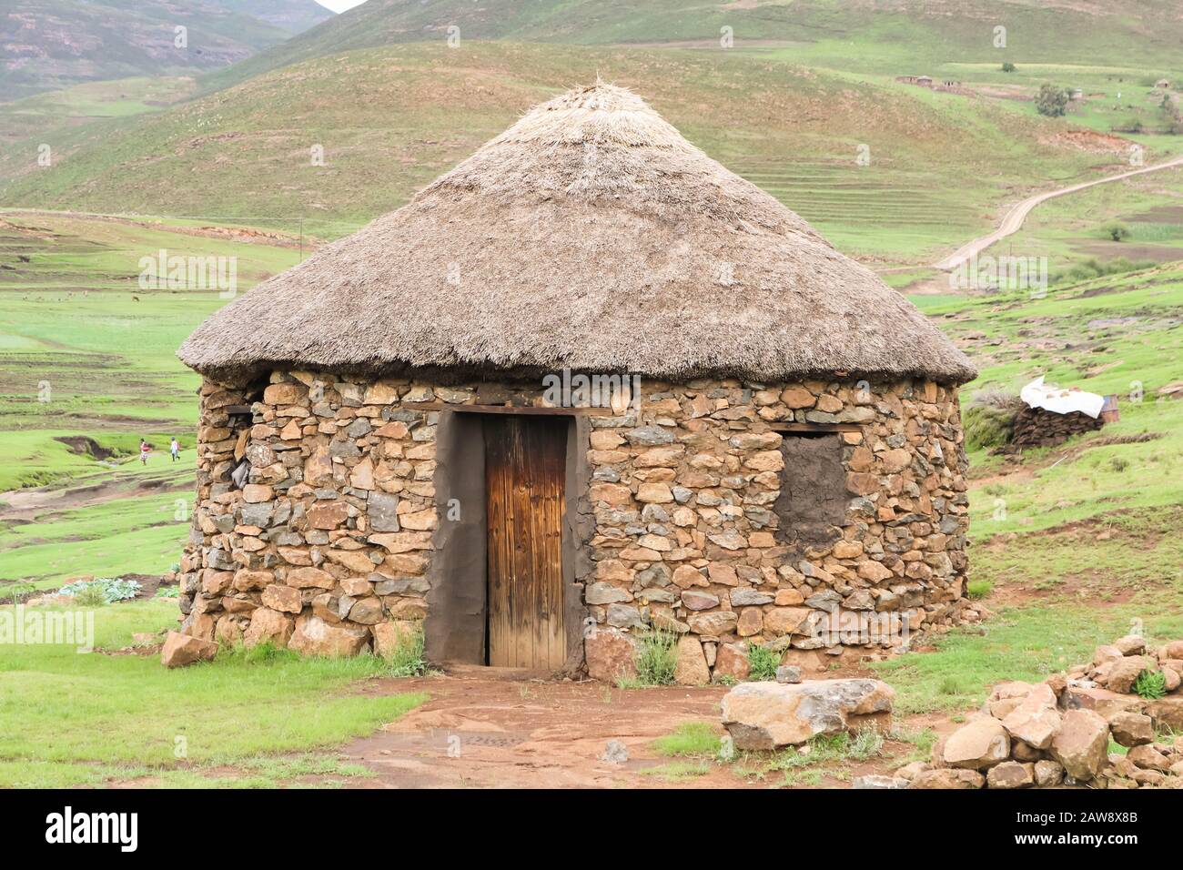 traditional stone bungalow with straw roof without people Stock Photo