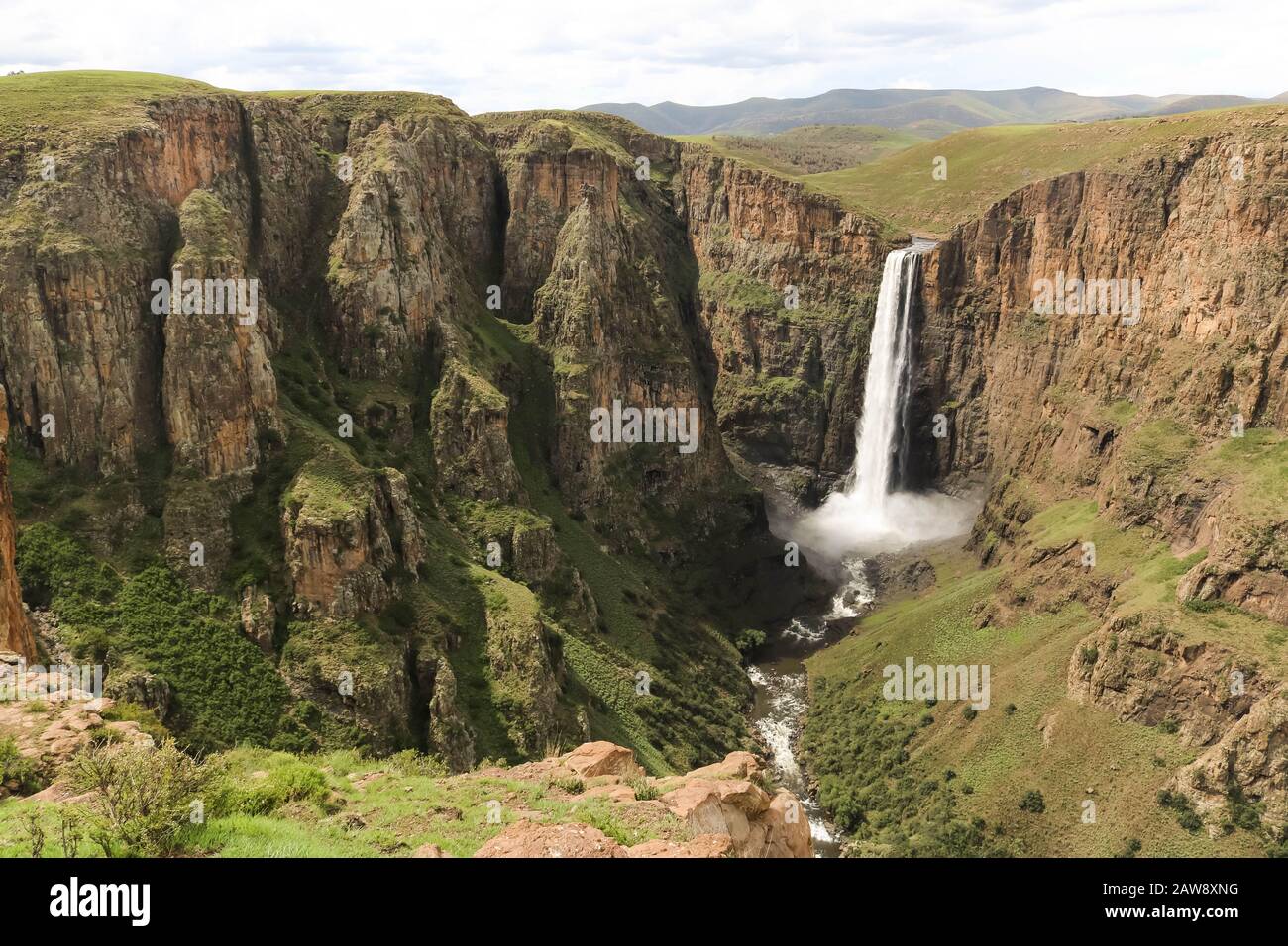 stunning waterfall running down a steap canyon Stock Photo