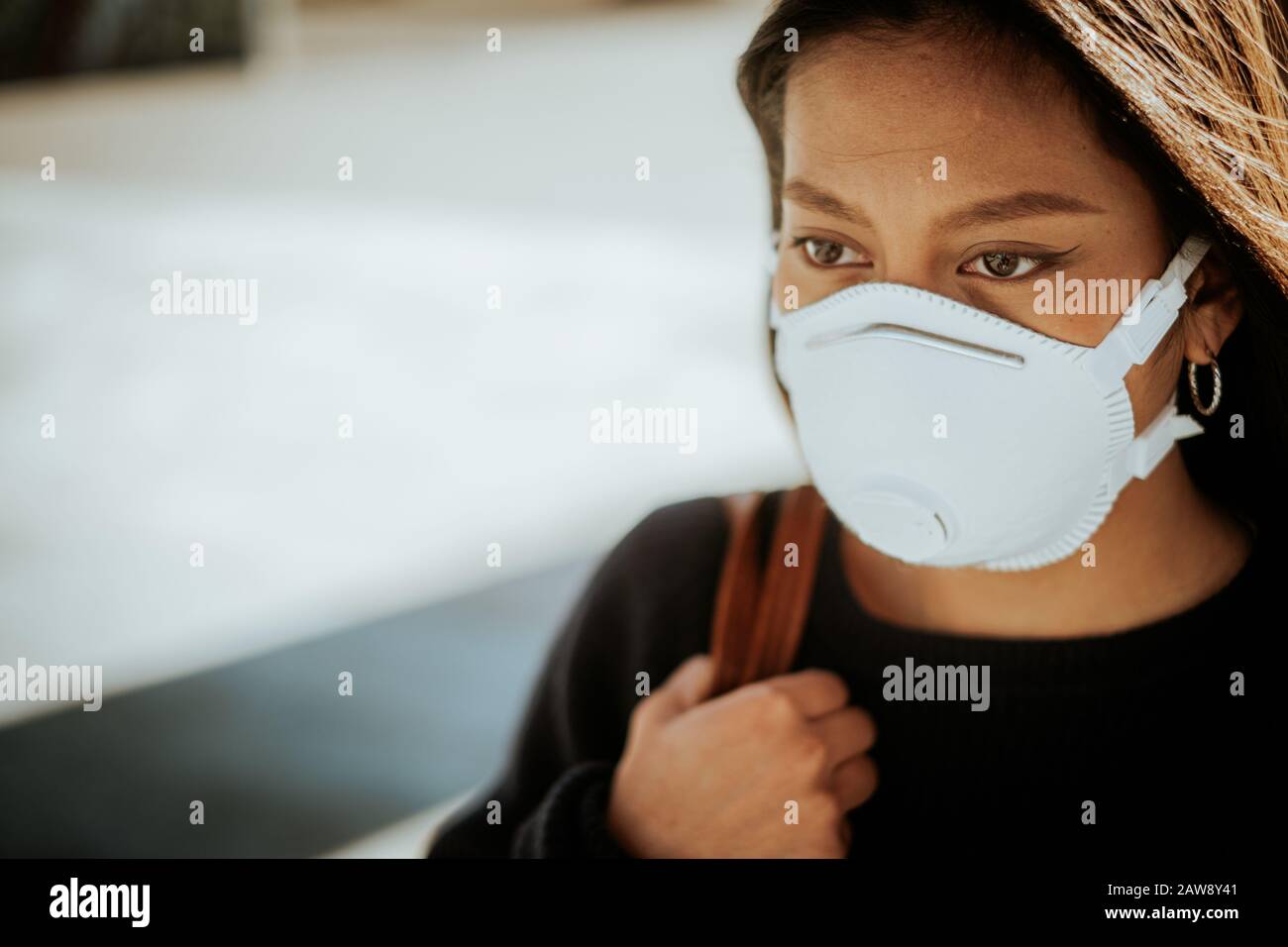 A chinese woman with a breathing mask to avoid infection danger Stock Photo