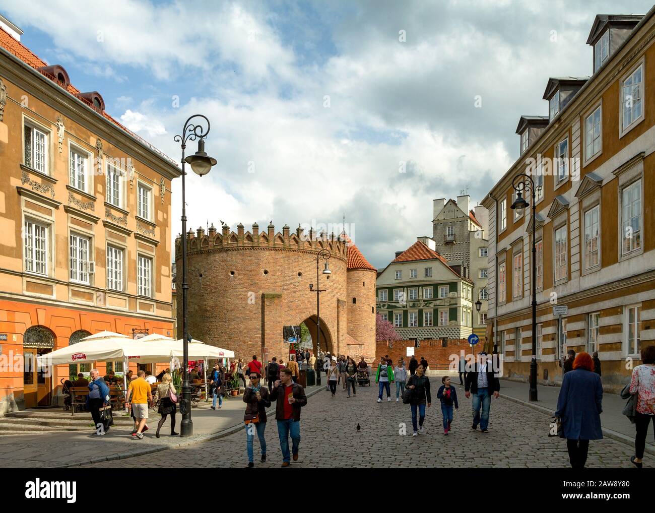 People walking on Nowomiejska by the Barbican of Old Town Warsaw Stock Photo