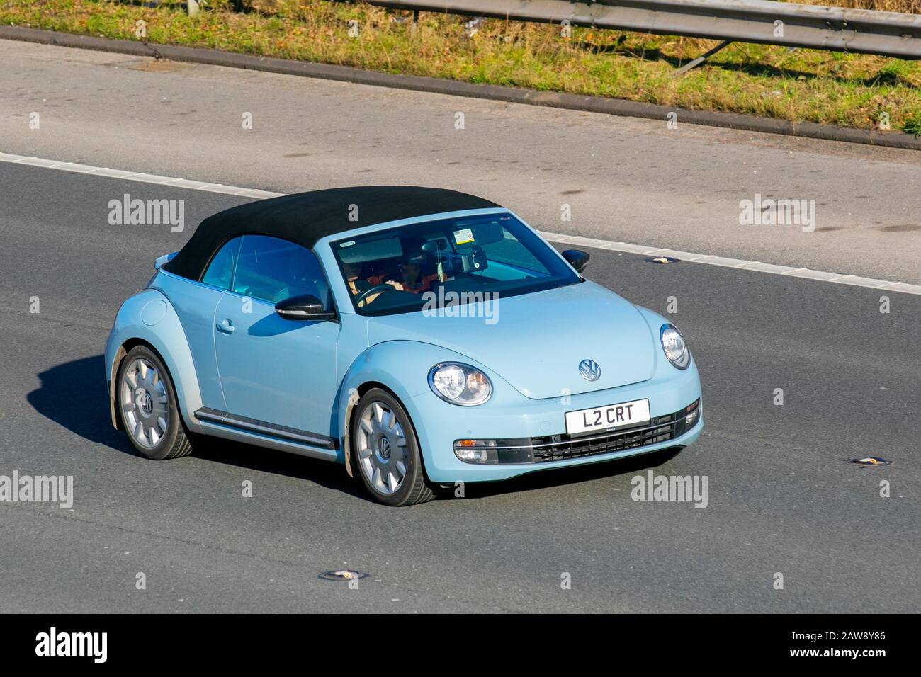2014 blue VW Volkswagen Beetle Sport TSI; UK Vehicular traffic, transport, modern, saloon cars, on the M61 motorway, Manchester, UK Stock Photo