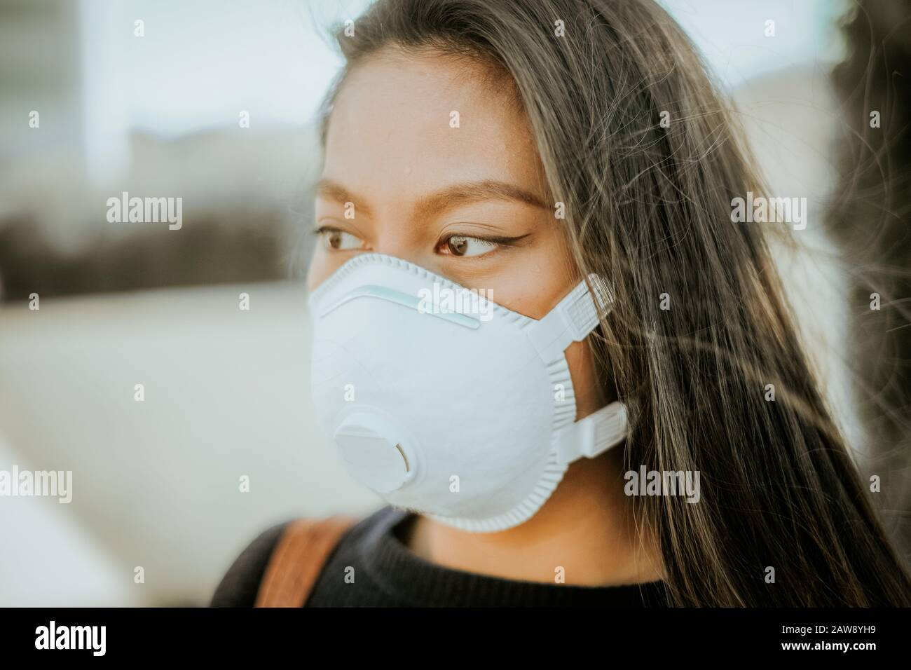 A chinese woman with a breathing mask to avoid infection danger Stock Photo