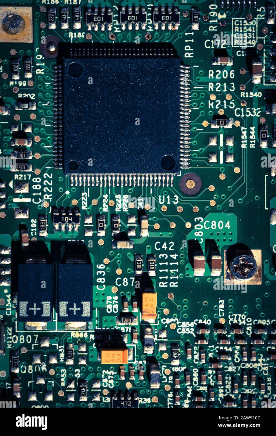 Closeup on computer circuit board chips, cross processed effeck colour