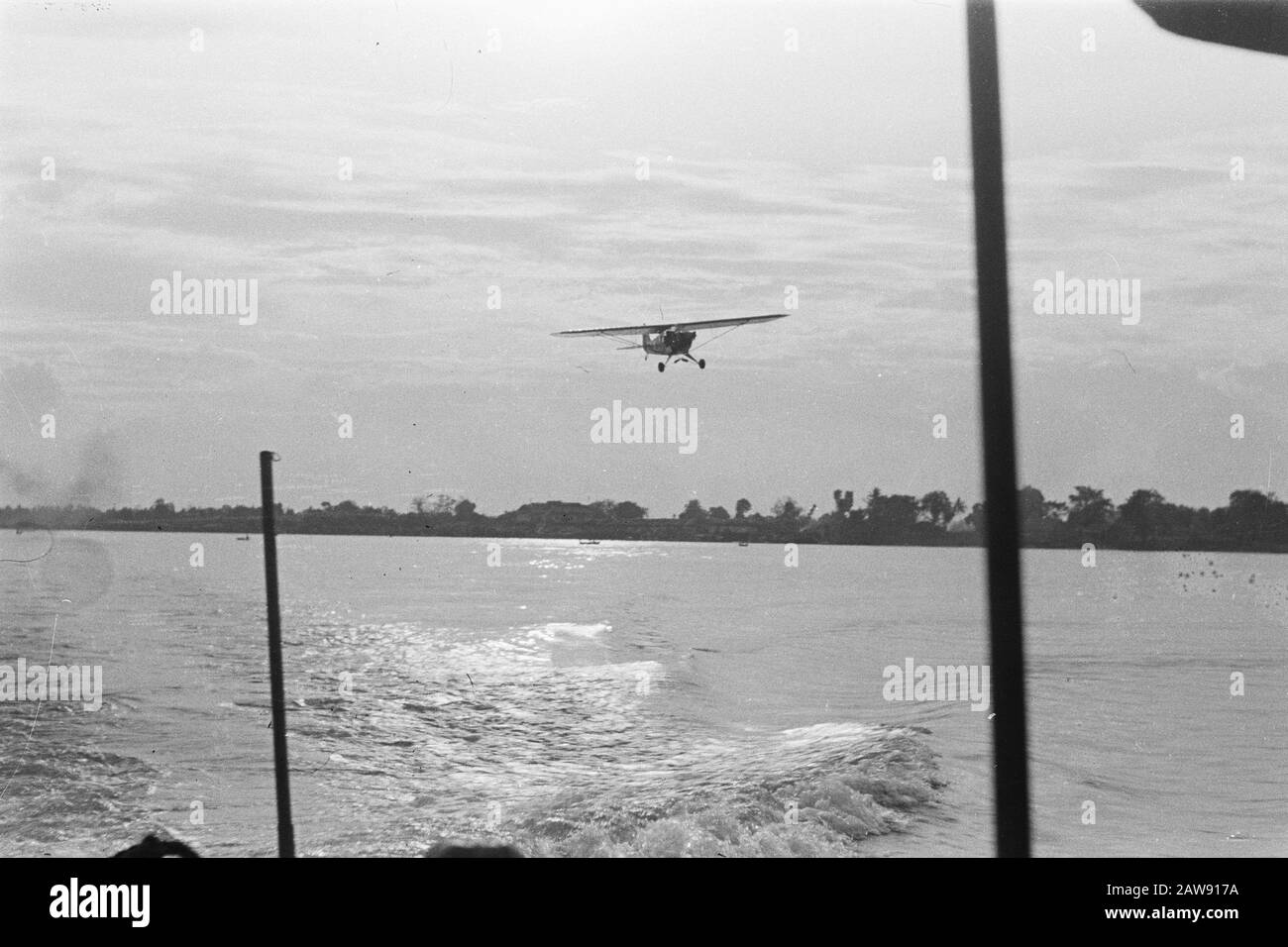 Light plane above a river Date: July 1947 Location: Indonesia Dutch East Indies Stock Photo