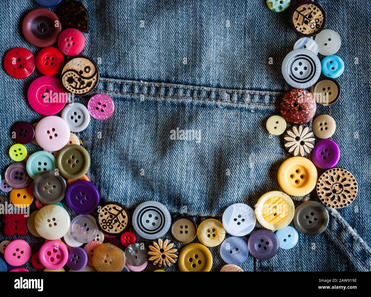 sewing buttons on denim jeans background Stock Photo Alamy