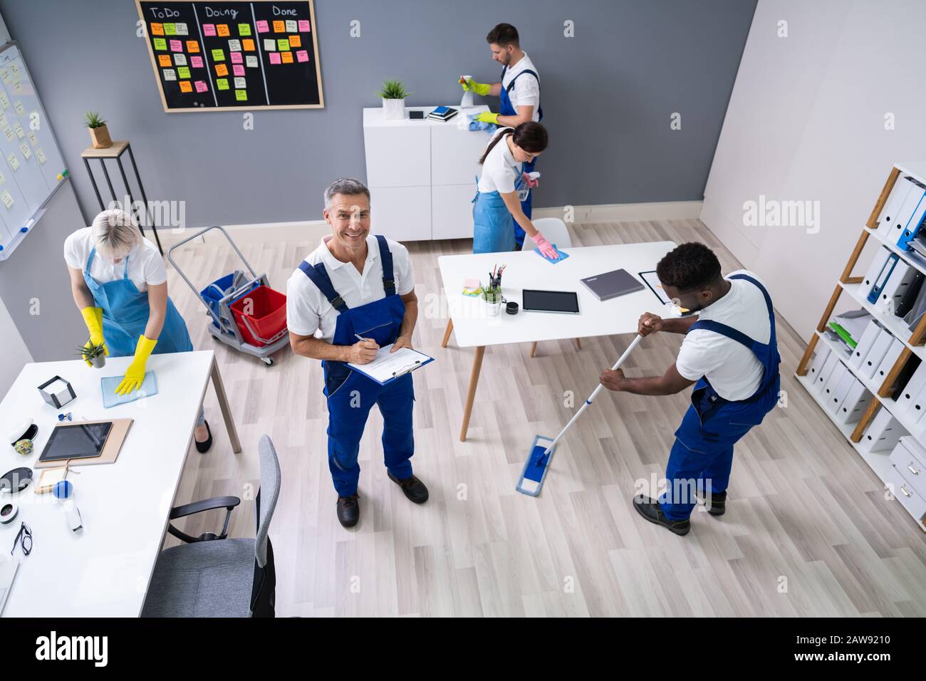 Janitor With His Team Cleaning Modern Office Stock Photo Alamy