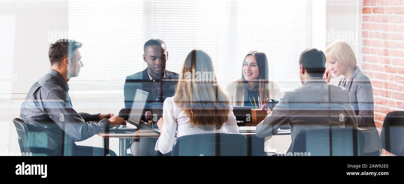 Diverse Group Of Businesspeople At Meeting In Office Stock Photo