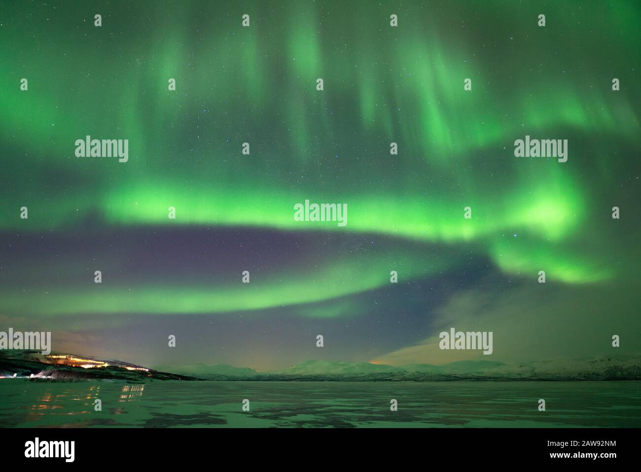 Northern lights over Abisko, frozen lake, snow and polar temperatures in Swedish Lapland Stock Photo