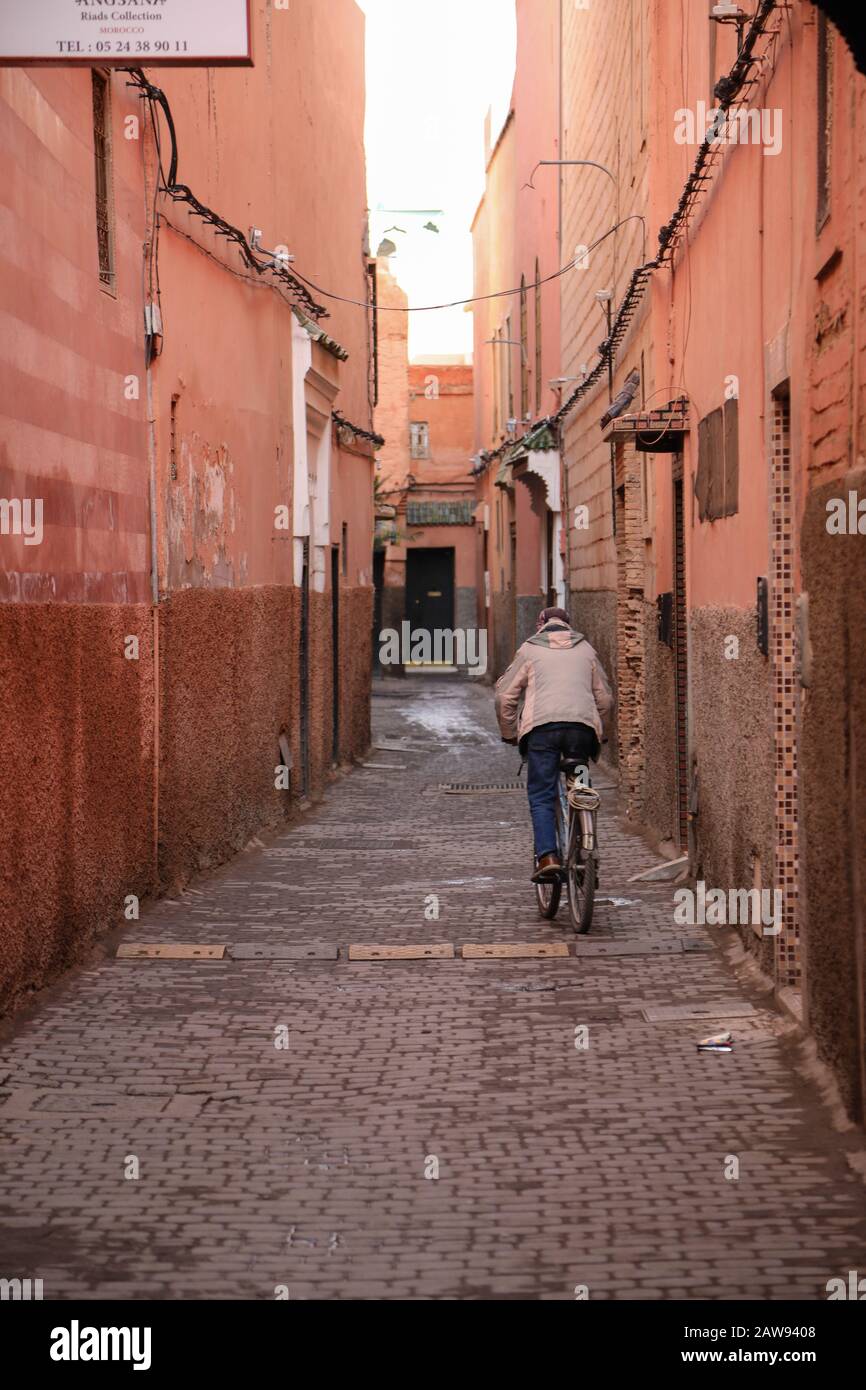 Man on bike in Morocco alley Stock Photo