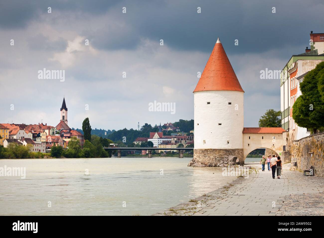 Tourists walking towards the Schaiblingsturm on the quayside of the River Inn at Passau, Bavaria, Germany Europe Stock Photo