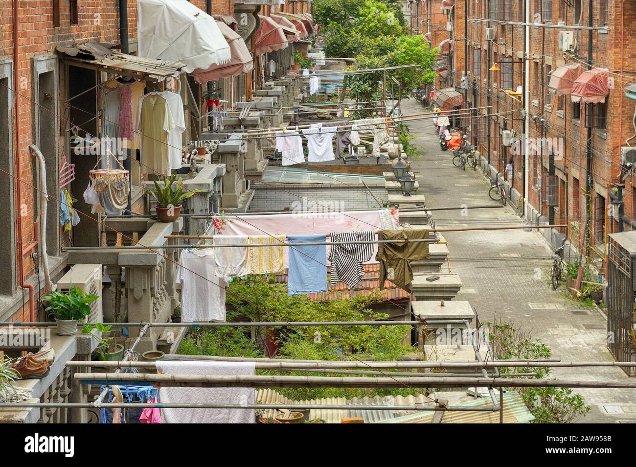 Typical, picturesque French concession quarter in old Shanghai, with hanging drying clothes and brick buildings. Stock Photo