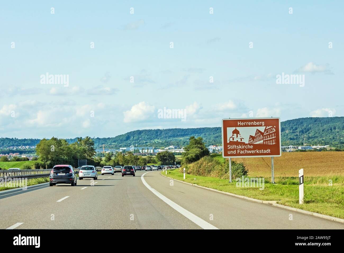 road sign city of Herrenberg 'Stiftskirche und Fachwerkstadt' at freeway, german Autobahn Stock Photo
