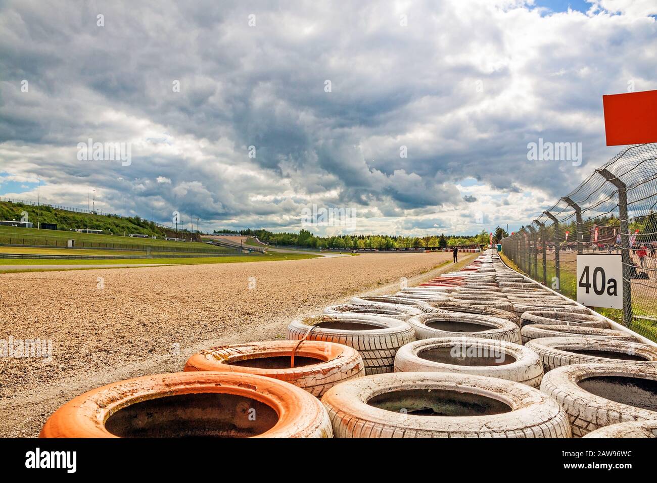 Nurburg, Germany - May 20, 2017: Race track Nurburgring - gravel bed beside speedway with orange, white tyre stack Stock Photo