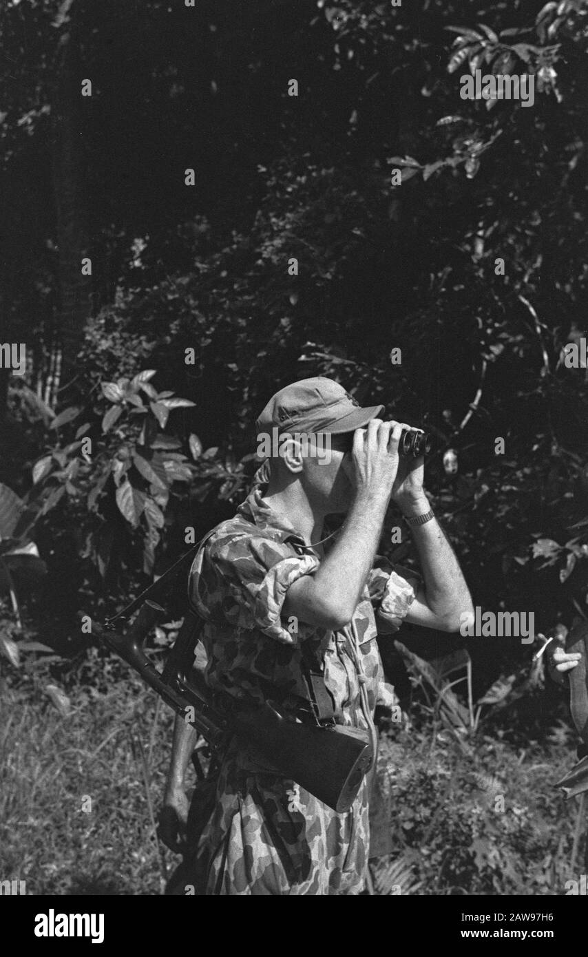Loeboek Pakem and Baoengan  Dutch soldier looks through binoculars Date: July 29, 1948 Location: Indonesia, Dutch East Indies, Sumatra Stock Photo
