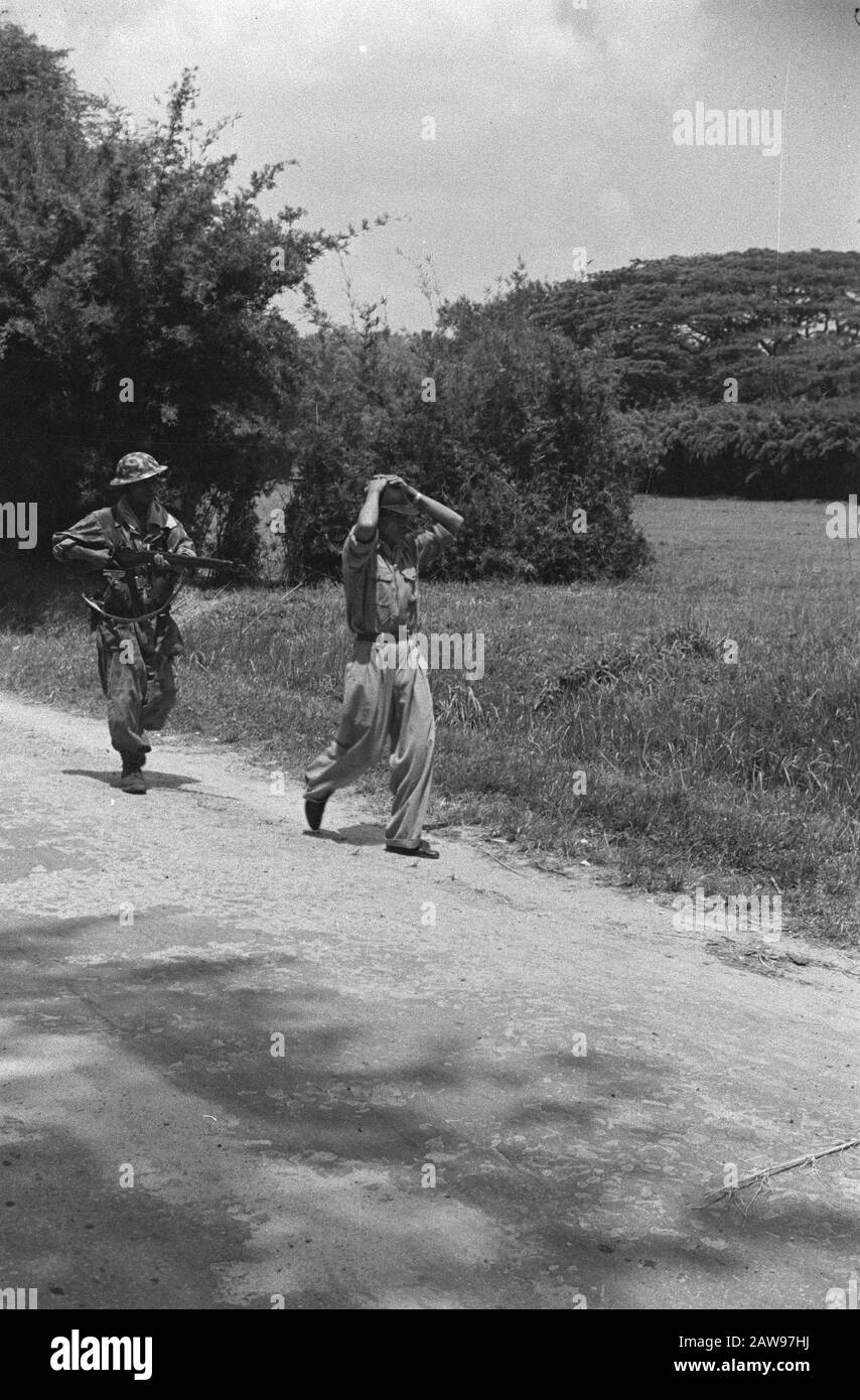 Loeboek Pakem and Baoengan description: Man in Japanese is uniform with hands on head held at gunpoint by Lower Lande military Date: July 29, 1948 Location: Indonesia, Dutch India, Sumatra Stock Photo