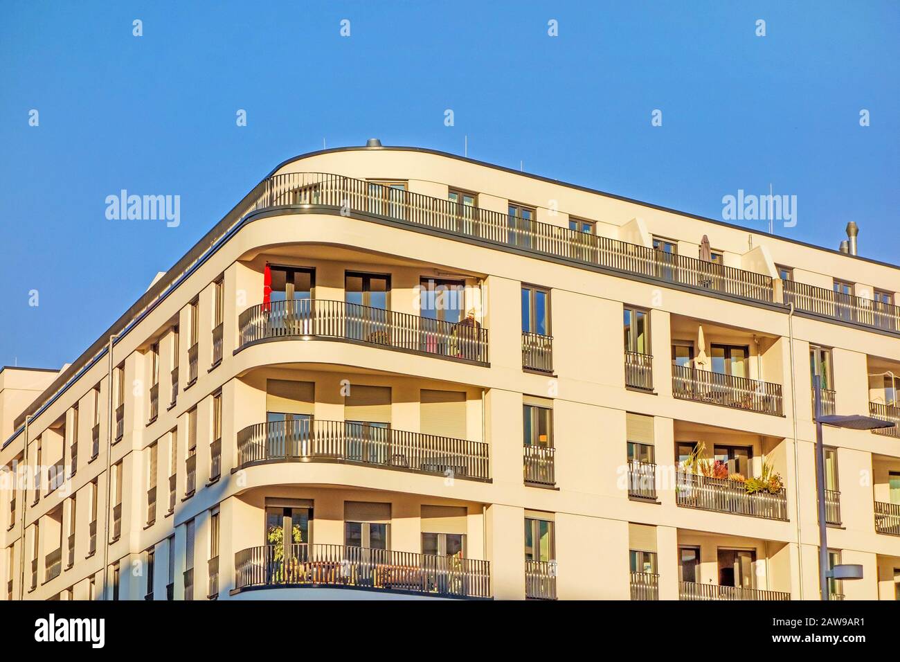 Apartment building facade with balconies, urban - blue sky Stock Photo ...