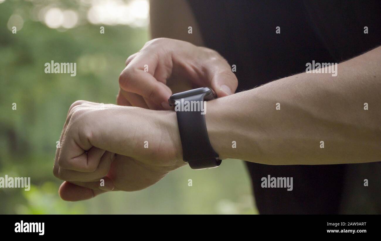 Making various gestures with a finger on a touch screen of a smart watch wearable device. Stock Photo