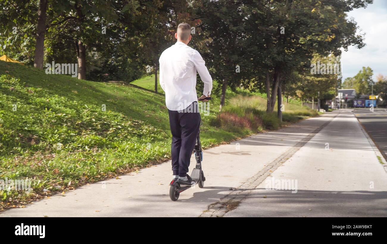 Happy man riding a scooter hi-res stock photography and images - Alamy