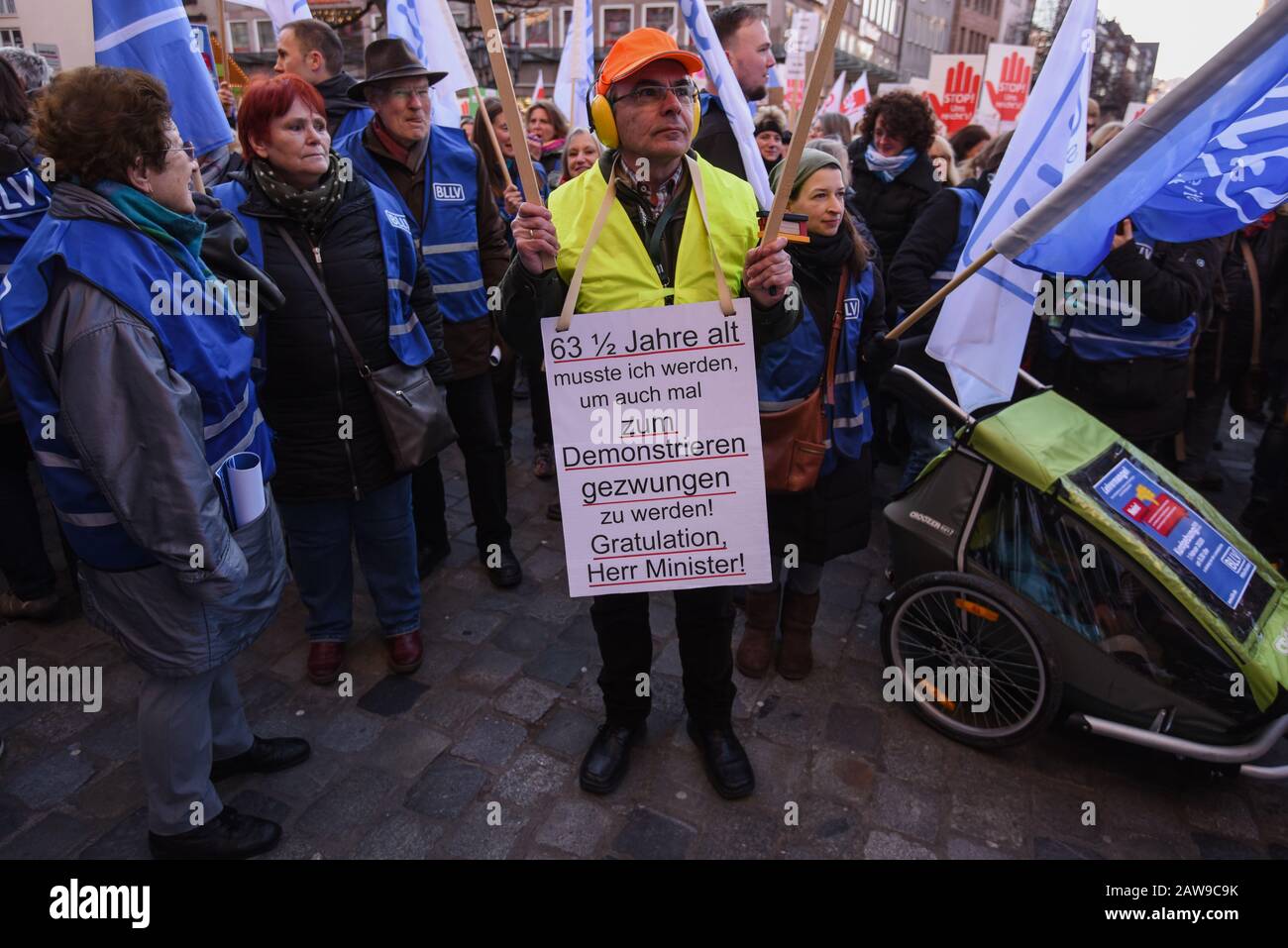 Nuremberg, Germany. 07th Feb, 2020. A man carries a sign at a demonstration with the inscription '63 1/2 years I had to become, in order to be forced to demonstrate! Congratulations, Mr. Minister'. The GEW union and the Bavarian Teachers' Association (BLLV) held a rally against the Bavarian Ministry of Education's package of measures to combat the shortage of teachers. Credit: Nicolas Armer/dpa/Alamy Live News Stock Photo