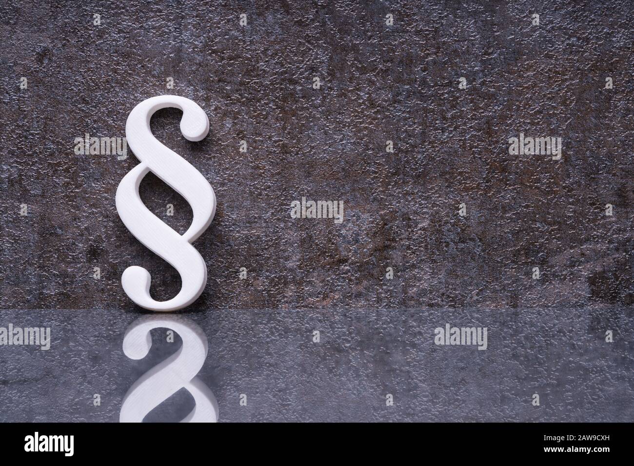 Close-up Of A Paragraph Symbol Leaning On Dark Wall Stock Photo