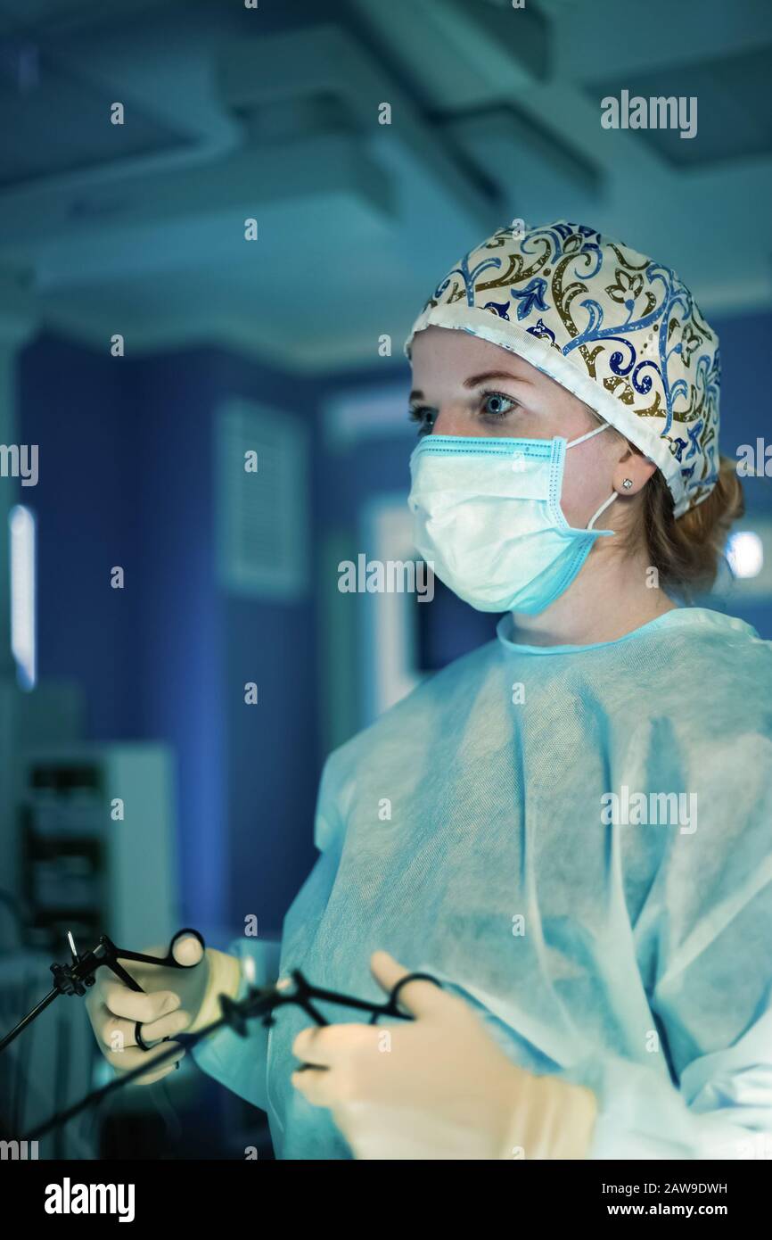 Surgeon woman doing surgical operation with laparoscopic instruments