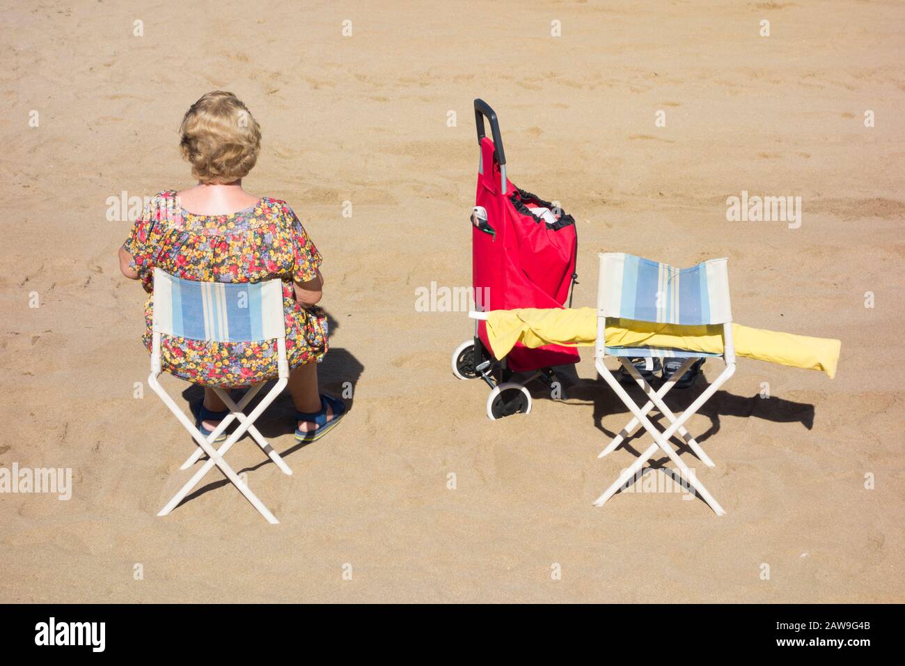 Rear view of elderly woman on beach Stock Photo - Alamy