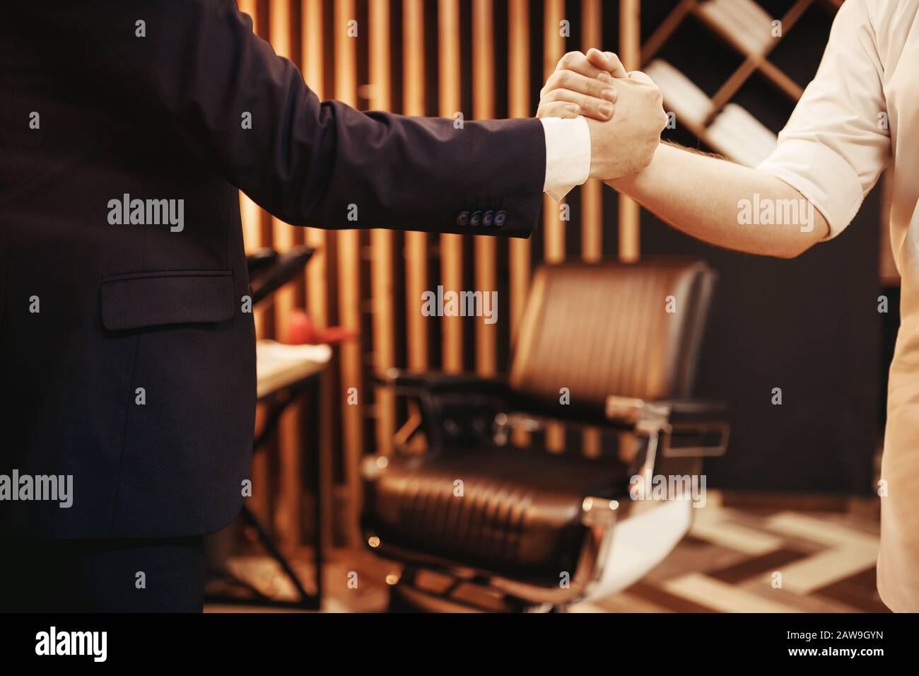 Barber customer with handshake at hairdresser