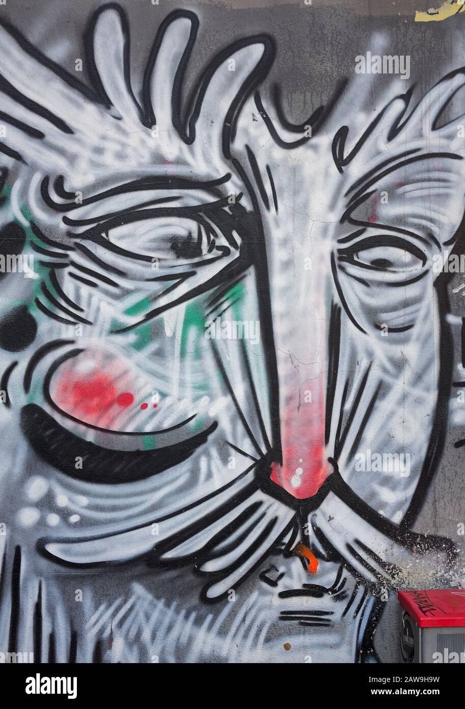 Modern graffiti in a street of Porta Romana distrect in Milan, Italy, depicting a funny face Stock Photo