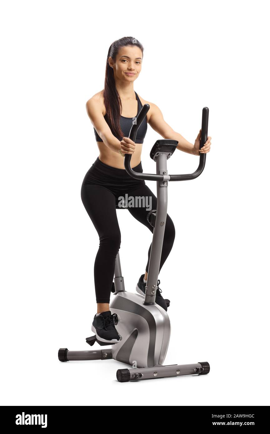Young sporty female exercising on a stationary bike isolated on white background Stock Photo