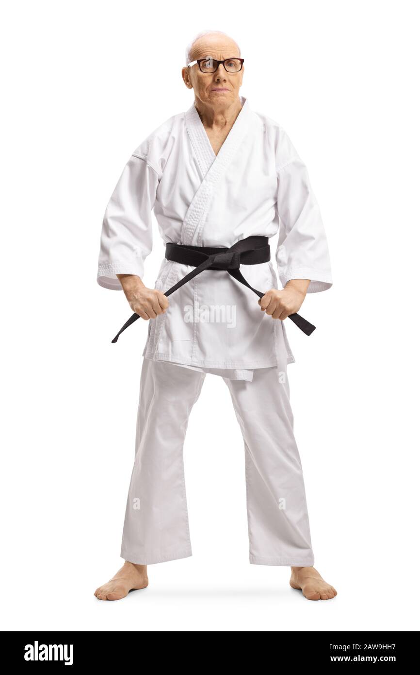 Full length portrait of a senior male karate master with black belt posing isolated on white background Stock Photo