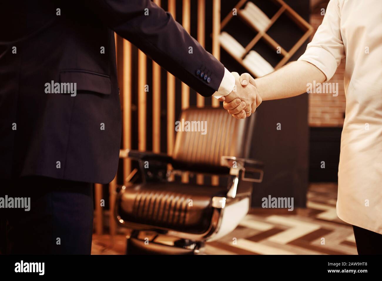 Barber customer with handshake at hairdresser