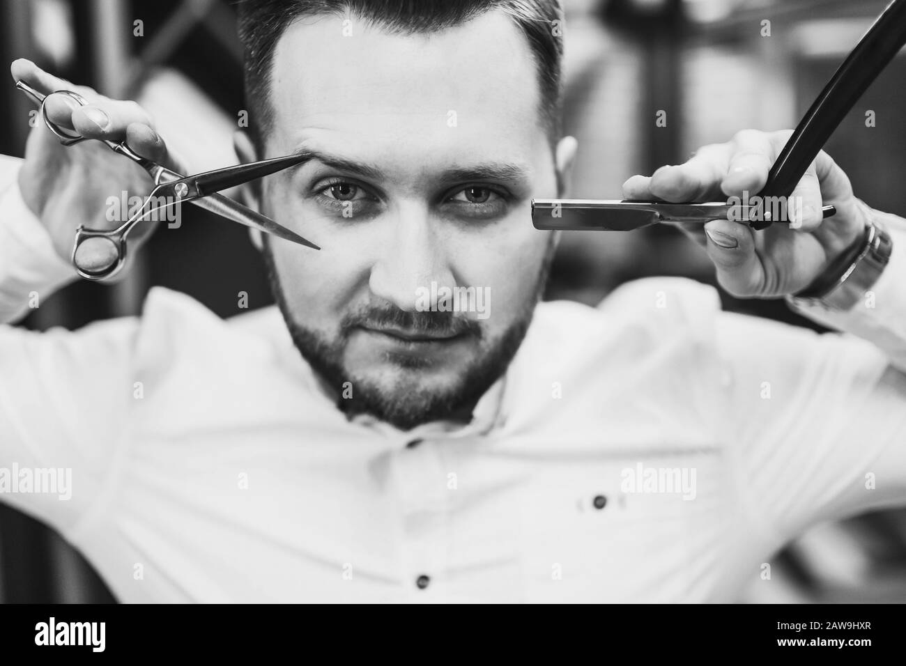 Barber shop. Man in chair, hairdresser styling his hair Stock Photo Alamy