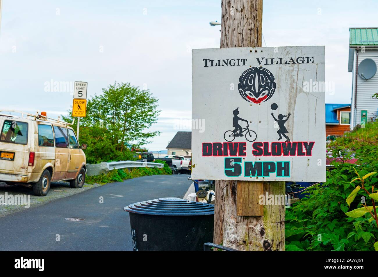 Street scene and Drive Slowly sign on Kaagwaantaan street in Sitka, Alaska, USA Stock Photo
