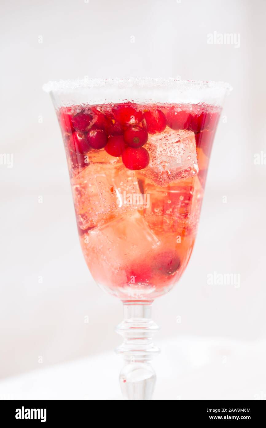 Glass of champagne and cranberry cocktail. Lightweight background. Vintage style. Vertical, macro Stock Photo