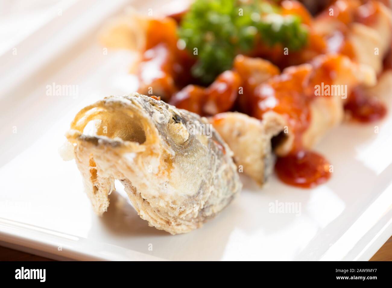 Japanese style fried sea bass, served with sweet and sour sauce. Far east restaurant cuisine